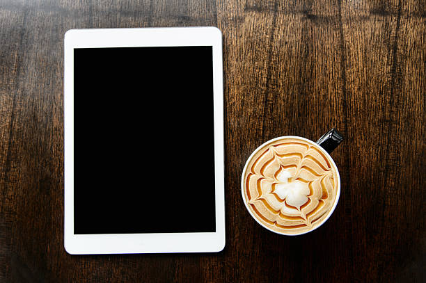istock tablet on wood desk on top view 523040802