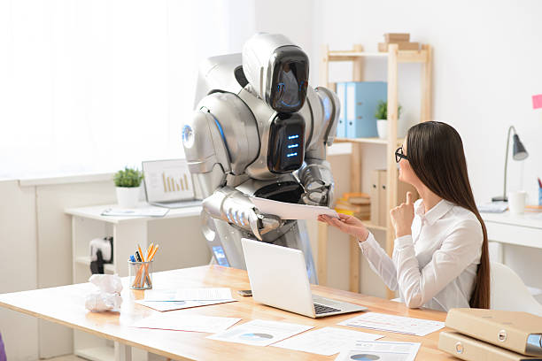 istock Pleasant girl and robot working in the office 523042412