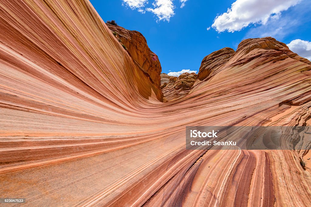 Entrance of The Wave Low angle view of swirling sandstone rocks and buttes at north "entrance" of The Wave - a dramatic and colorful erosional sandstone rock area in North Coyote Buttes at Arizona-Utah border. Jurassic Stock Photo