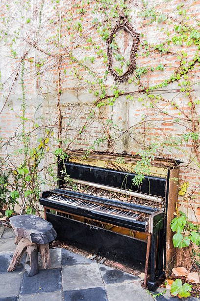 istock old piano with concrete wall and leaf 523048898