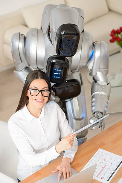 istock Pleasant girl and robot working in the office 523049920