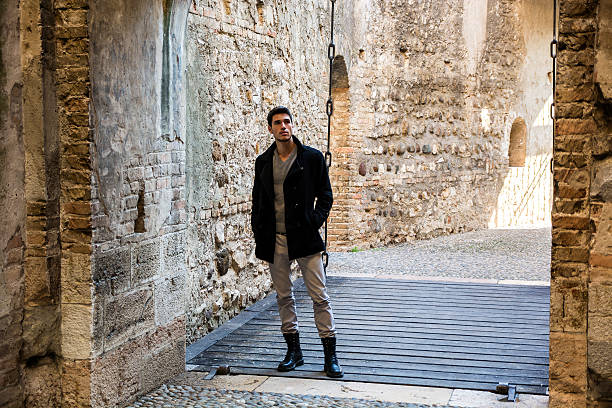 istock Attractive young man standing at castle entrance 523052032