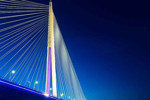Ada Bridge at night, Belgrade, Serbia Detail of bridge cables and deck. Ada Bridge (Most na Adi) a 969 m long and 200 m tall pylon bridge with six-lane roadway and unlaid double-track mass transit right-of-way is opened in 2012. cable stayed bridge stock pictures, royalty-free photos & images