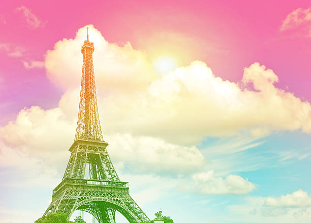 Eiffel Tower against colorful blue sunset sky. Champ de Mars, place of interest in Paris, Europe. Vintage style toned picture