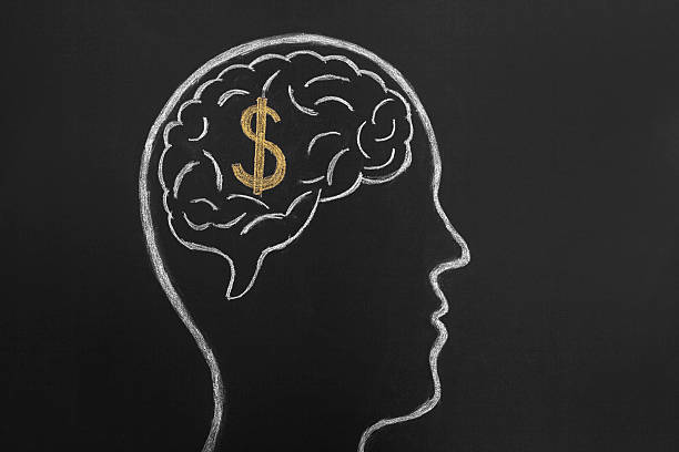 Thinking of money. Dollar sign inside brain sketched on blackboard.