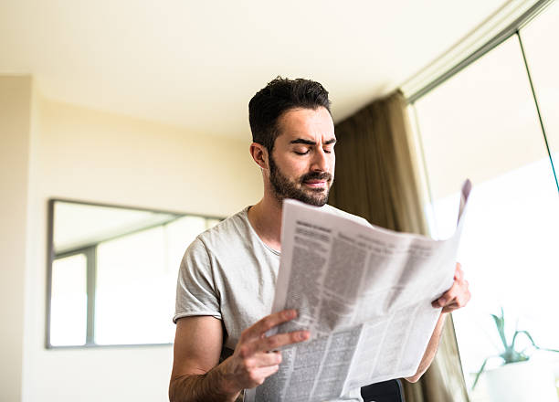 istock man reading the newspaper on bedroom 523054128
