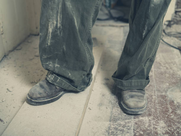 istock Feet of builder in boiler suit 523054520