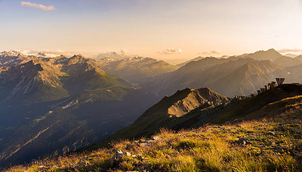 istock Warm light at sunset on mountain peaks, ridges and valleys 523056598