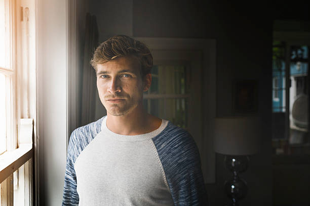 istock Portrait of confident man standing by window 523059024