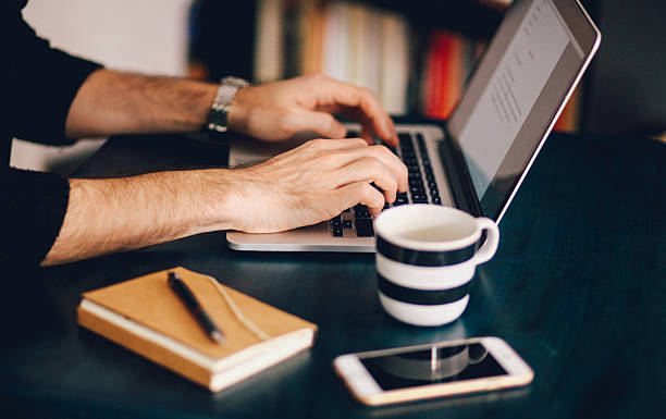 istock Young man typing at the laptop 523059478