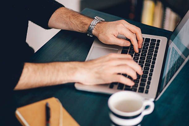 istock Young man typing at the laptop 523059506