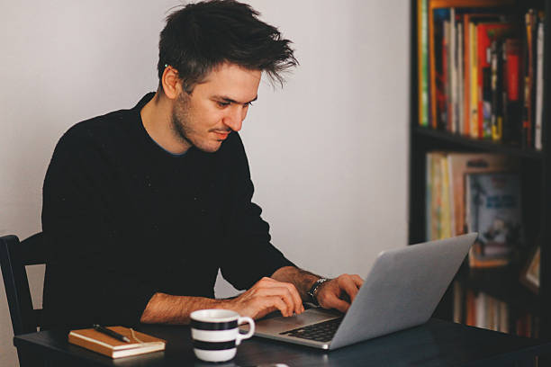 istock Young man typing at the laptop 523059622