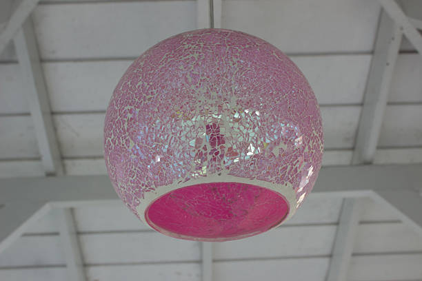 Modern pink hanging lamp, isolated on white background.