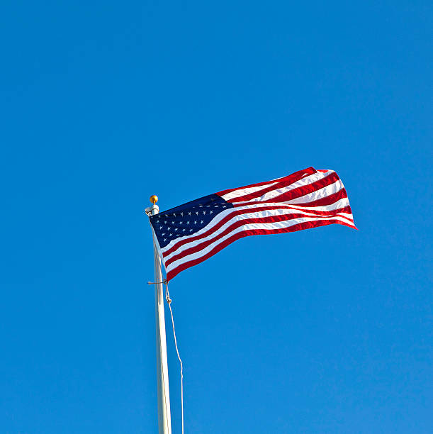 istock American flag waving against a brilliant blue sky 523087957