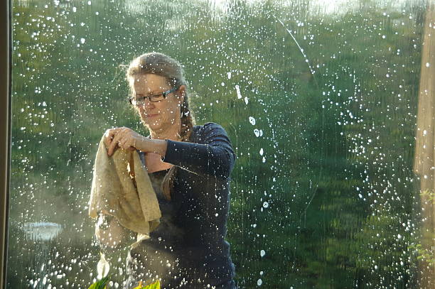 istock Women is cleaning the window 523089869