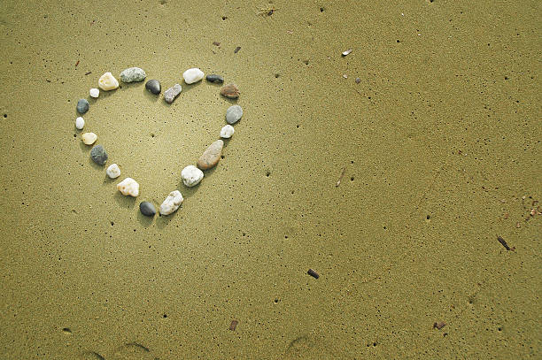 istock Heart drawn at sand. Sea beach background 523093019