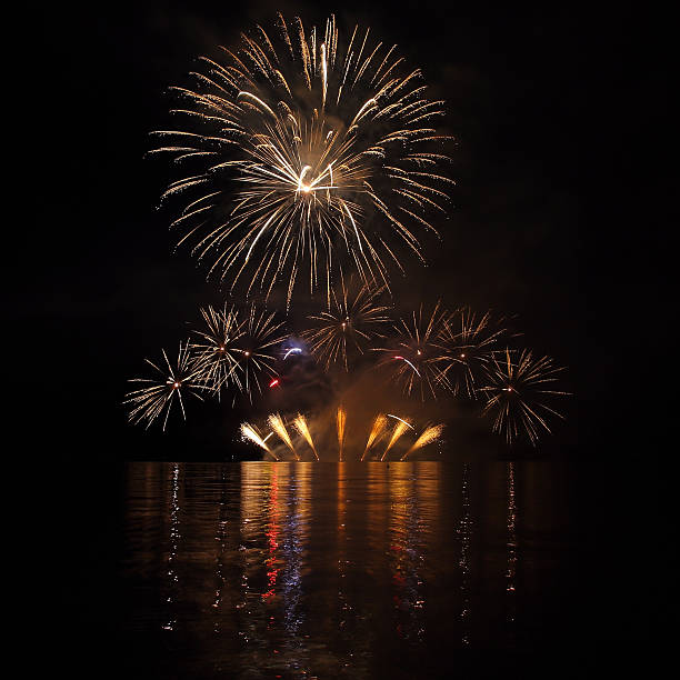 Colorful fireworks with reflection on lake. stock photo