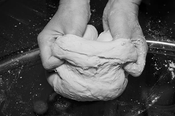 Hands kneading a dough.