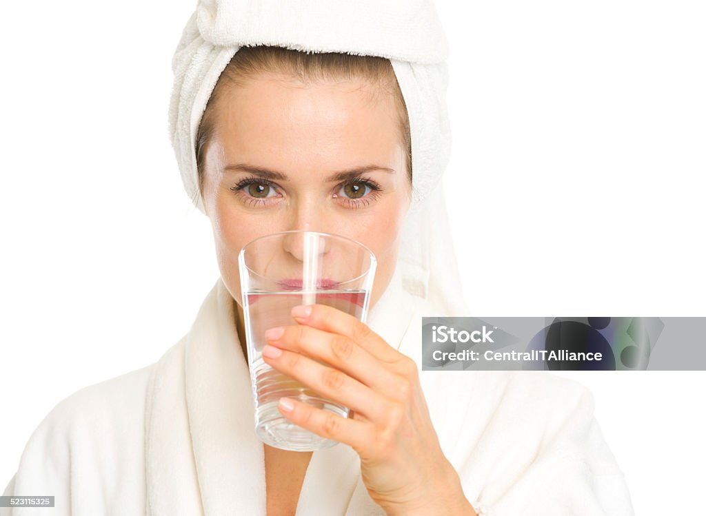 young woman in bathrobe drinking pure water Young woman in bathrobe drinking pure water Adult Stock Photo