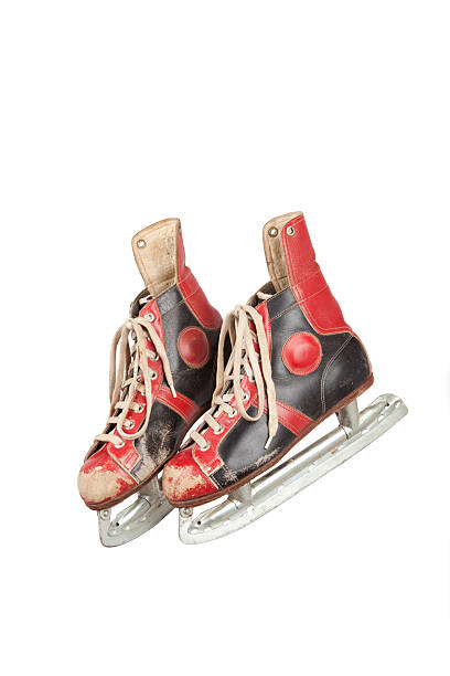 istock two retro ice skates, used, white background 523116545