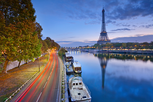 Image of Eiffel tower with the reflection in the Seine river.