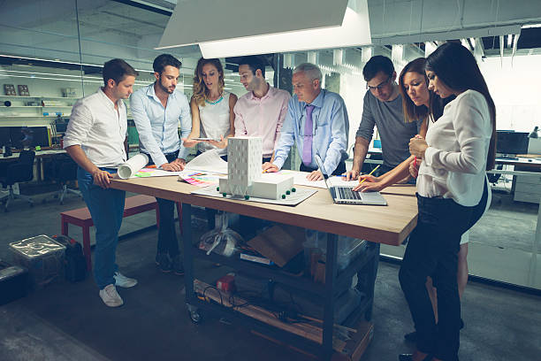 istock Group of architects reviewing architectural model in the office. 523131853