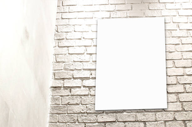 istock Blank Poster paper standing next to a white brick wall 523134249