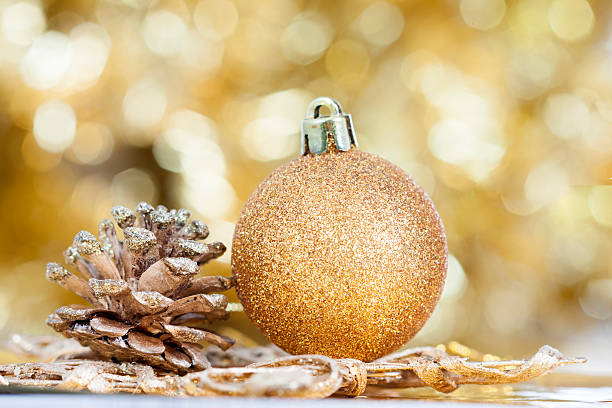 istock Closeup on decorations: golden christmas ball and cone 523134953
