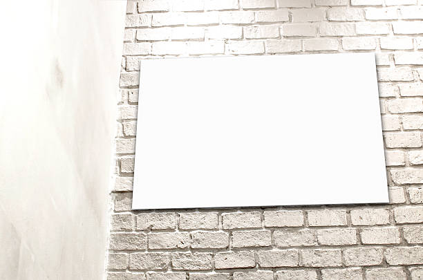 istock Blank Poster paper standing next to a white brick wall 523135971