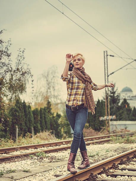 istock young woman walking on train tracks 523136813