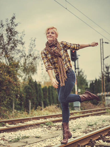 istock young woman walking on train tracks 523136845