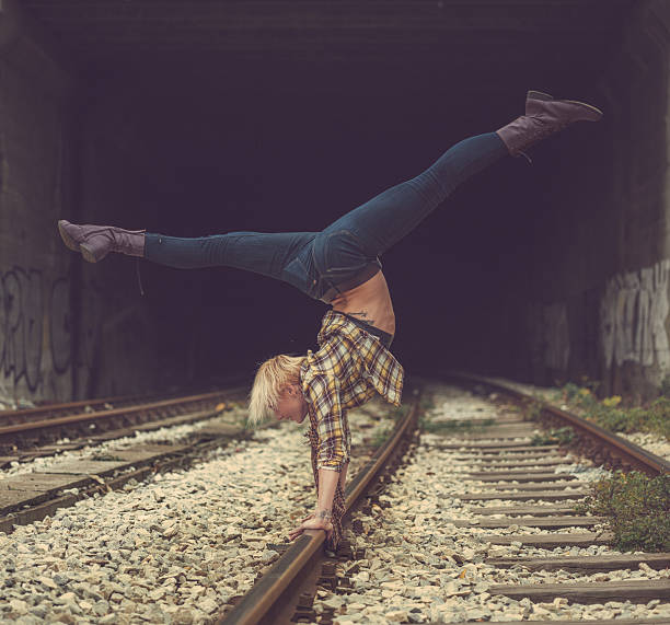 istock handstand on railroad tracks 523136899