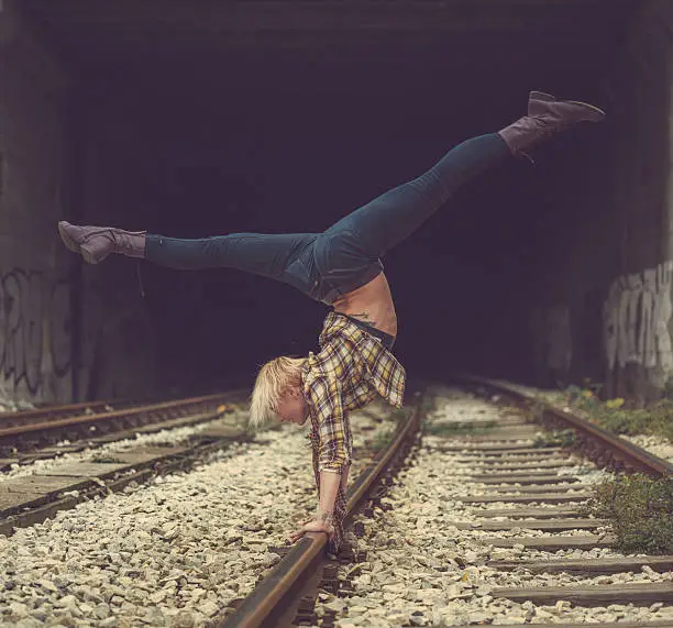 Photo of handstand on railroad tracks