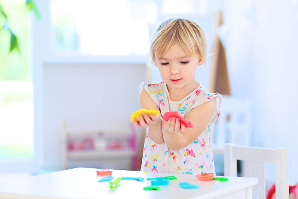 istock Toddler girl playing with plasticine 523137241