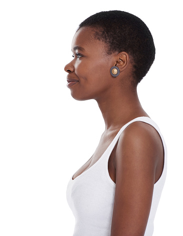 Profile shot of a smiling young woman standing against a white background