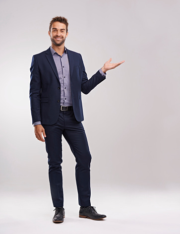 Studio shot of a well-dressed man against a gray background