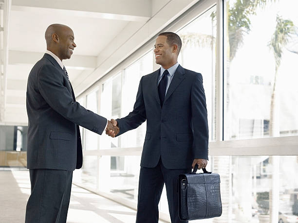 istock Businessmen Shaking Hands In Office Corridor 523138445