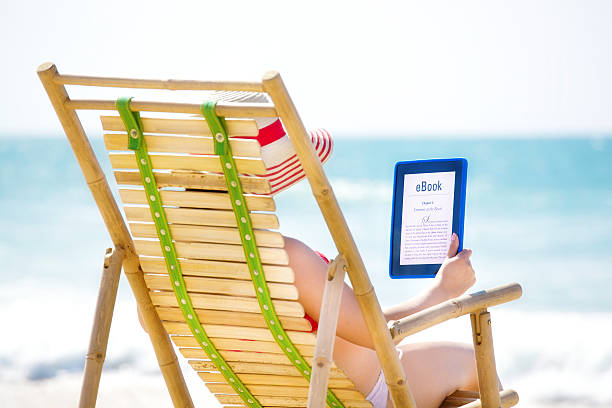 istock Woman Reading E-Book with Digital Tablet on Beach Vacation 523138835