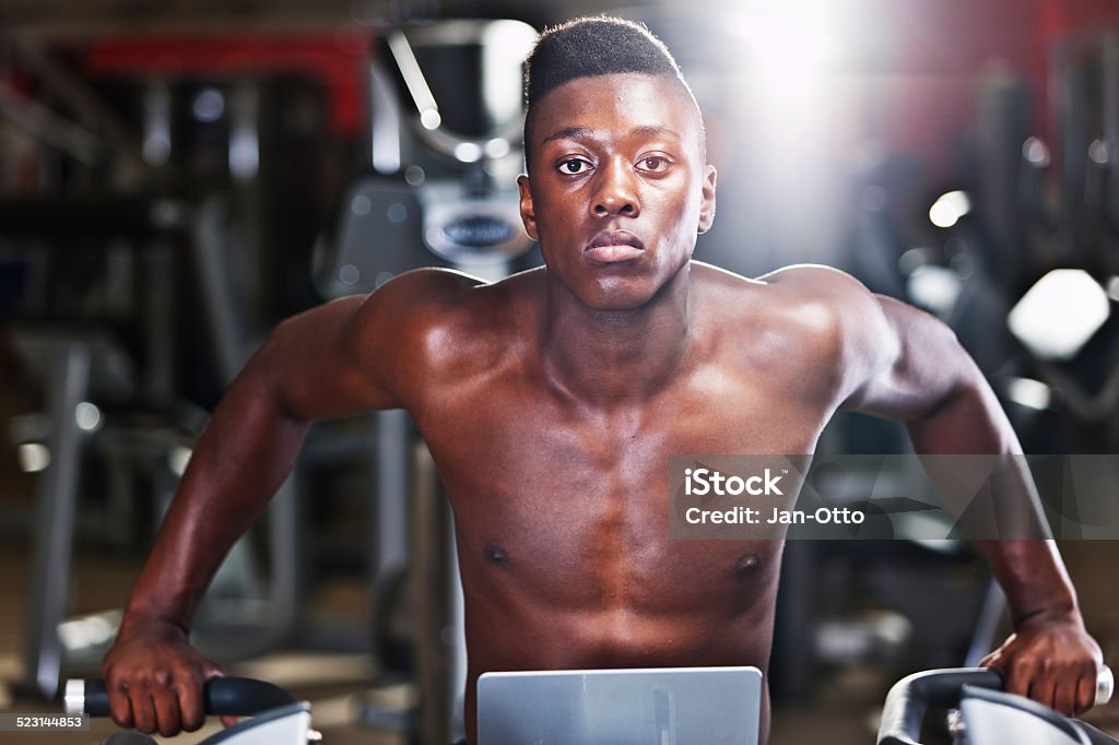 Black musculous guy A musculous young guy,  resting after a severe workout at the dips machine. XXL size image. 20-29 Years Stock Photo