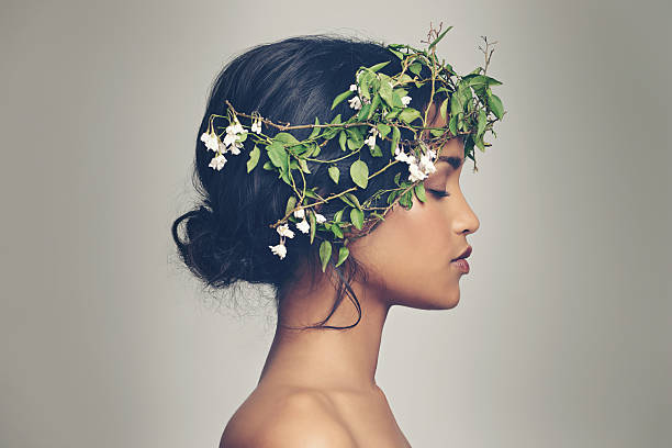Beauty and nature combined Studio shot of a beautiful young woman wearing a head wreath wreath photos stock pictures, royalty-free photos & images