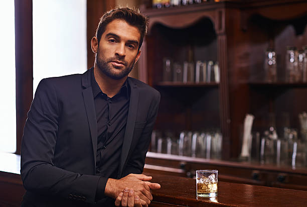 I prefer whiskey Cropped shot of a handsome and confident young man urbane stock pictures, royalty-free photos & images