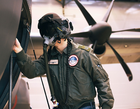 An airplane mechanic working on a private jet inside the hangar of a small general aviation airport in California.