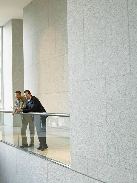 istock Businessmen Leaning On Railing In Office 523147391