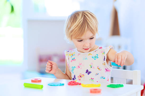 istock Toddler girl playing with plasticine 523147693