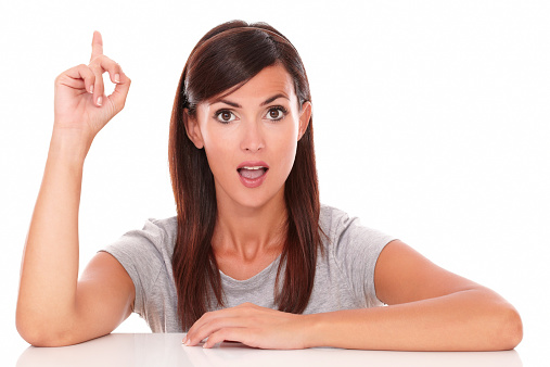 Portrait of surprised woman pointing up her finger while looking at you on isolated white background - copyspace