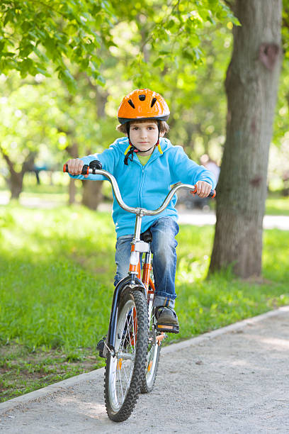 istock Little kid in blue jacket cycling 523149843