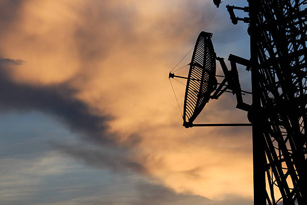 istock silhouette satellite communication tower poles on sunset 523150091