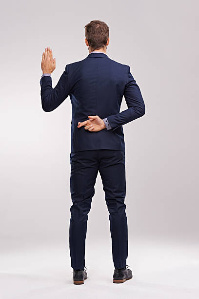 Nothing but the truth Rearview of a young man swearing an oath with his fingers crossed behind his backhttp://195.154.178.81/DATA/shoots/ic_784186.jpg hands behind back stock pictures, royalty-free photos & images