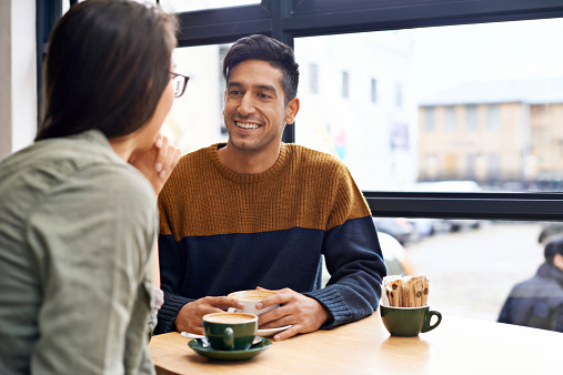 Cropped shot of a young couple sitting in a coffee shop on a date