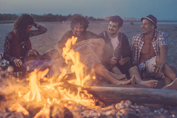 istock friends sitting around a camp fire 523154810